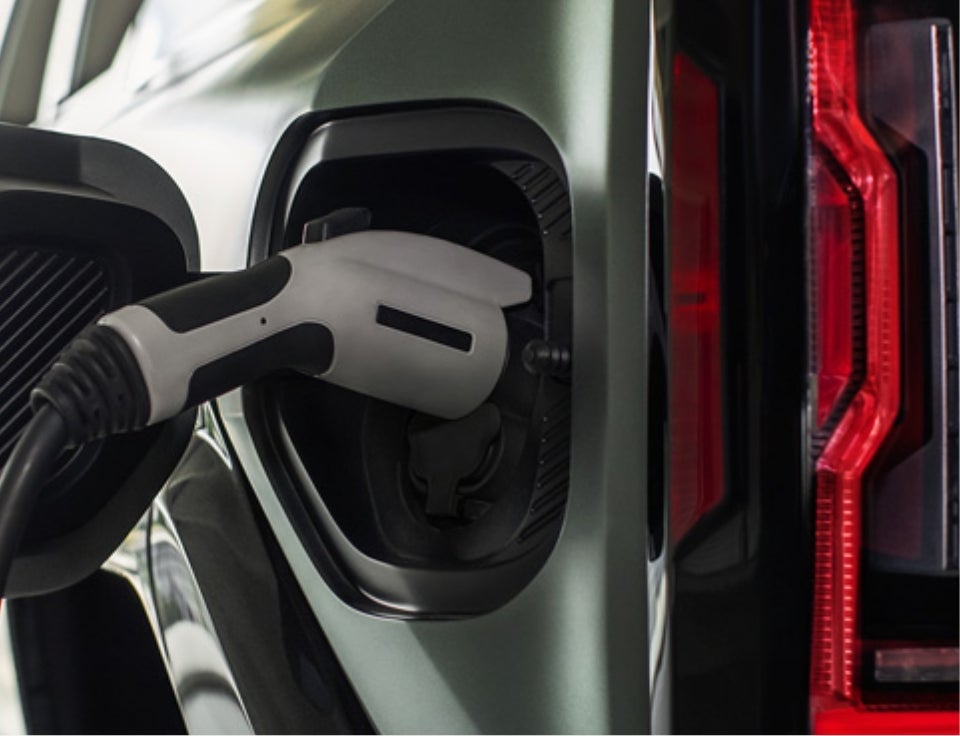 Close up of charging port with charger plugged in on a GMC Hummer EV SUV - Kemna Auto Center GMC in ALGONA IA