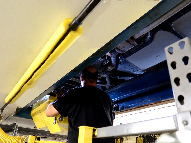 A Kemna Quick Lane technician performing service in Algona, IA