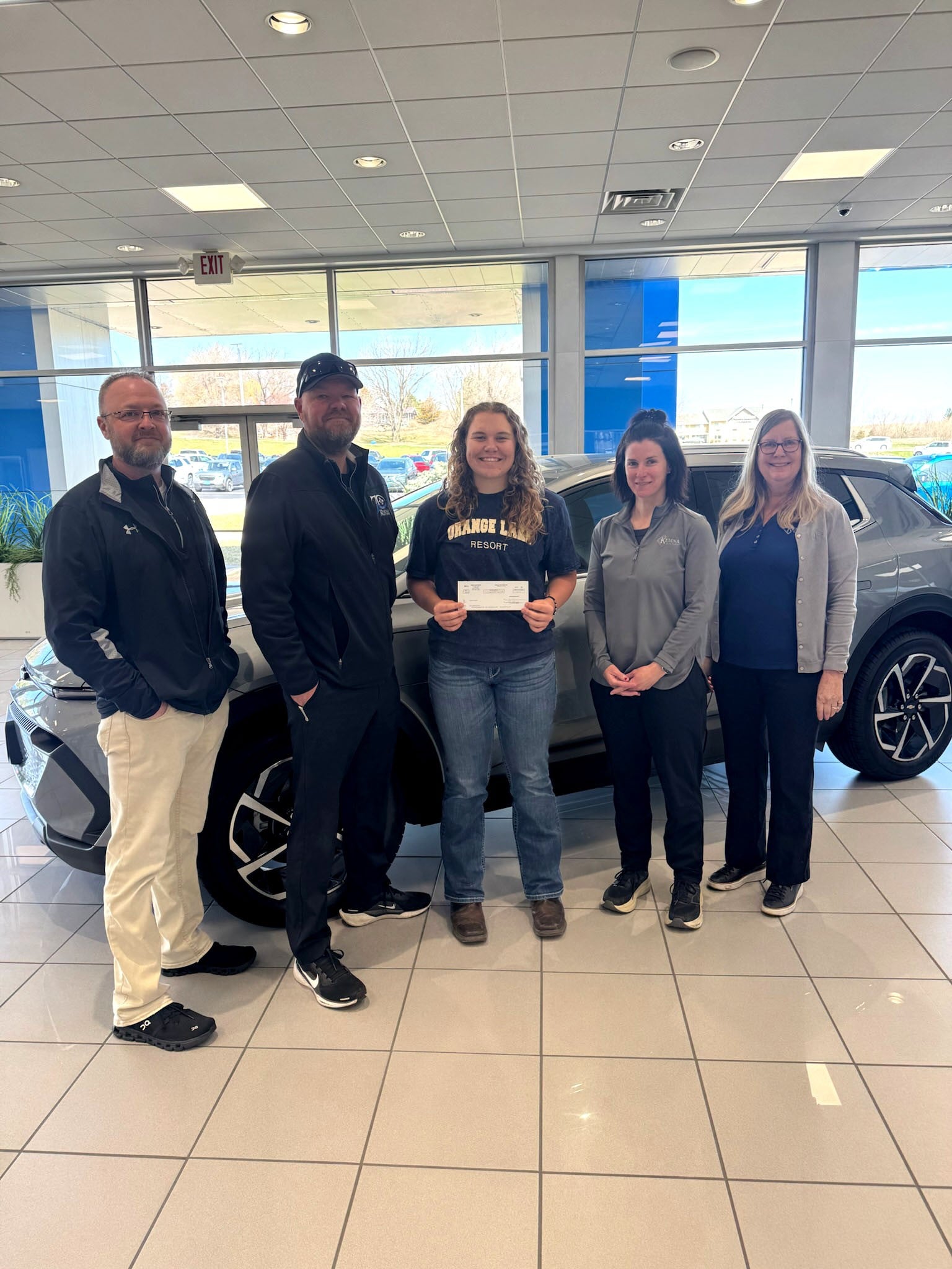 Loyal Kemna GMC customer celebrating the dealership's 70th anniversary in Algona, Iowa