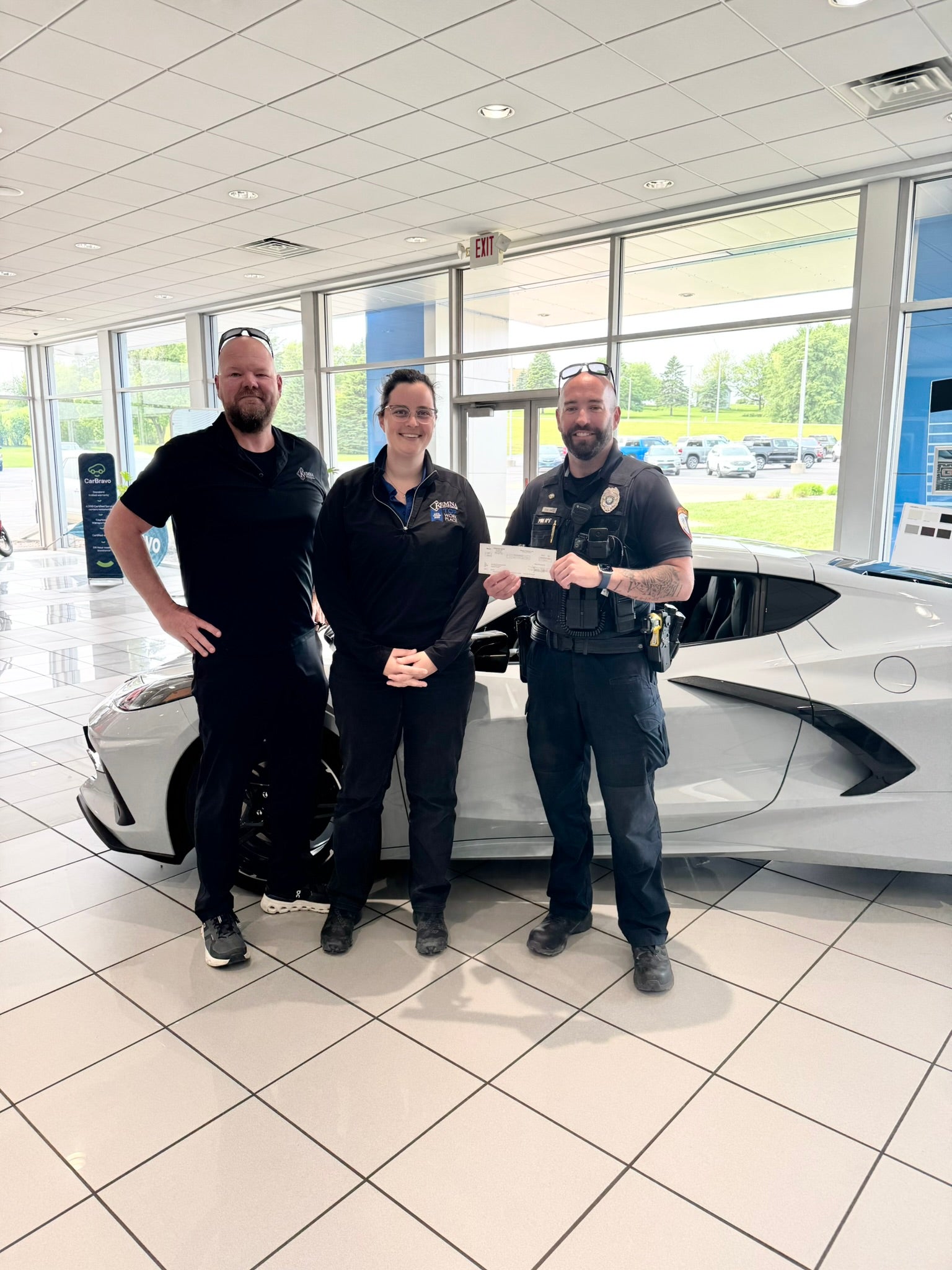 Kemna GMC team presenting a donation to the Algona Police Department