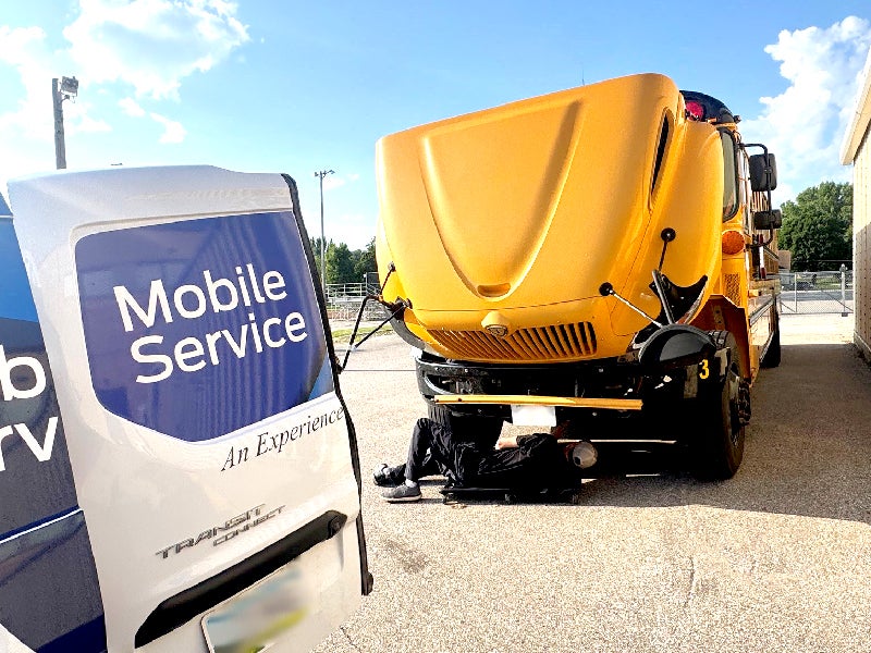 Kemna GMC Mobile Service Van performing service on a school bus
